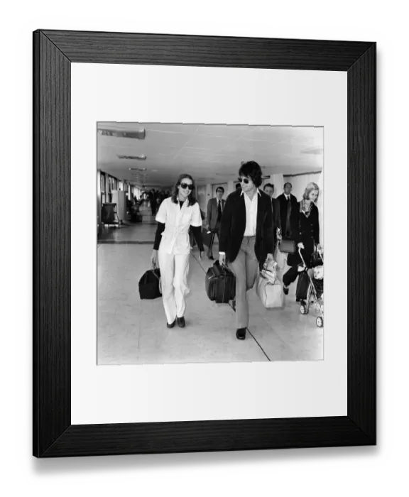 Framed Print : American actor Warren Beatty at Heathrow Airport with Michelle Phillips. May 1975 Framed Print : American actor Warren Beatty at Heathrow Airport with Michelle Phillips. May 1975