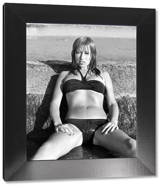 Model wearing a bikini as she poses on a beach in Africa April 1975