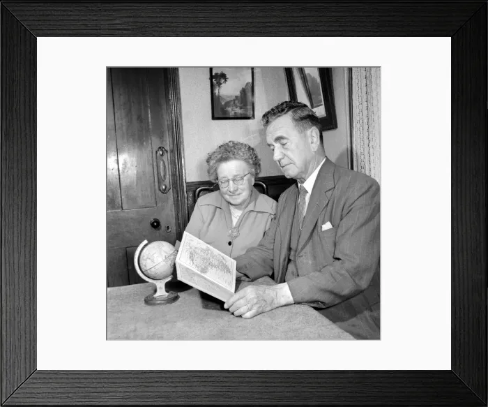 Framed Print : Holidays: Pensioners seen here looking at the globe deciding where to go to for their Framed Print : Holidays: Pensioners seen here looking at the globe deciding where to go to for their