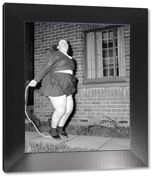 Slimming: Large woman skipping to get fit. A145-001