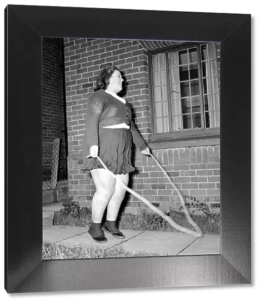 Slimming: Large woman skipping to get fit. A145-002