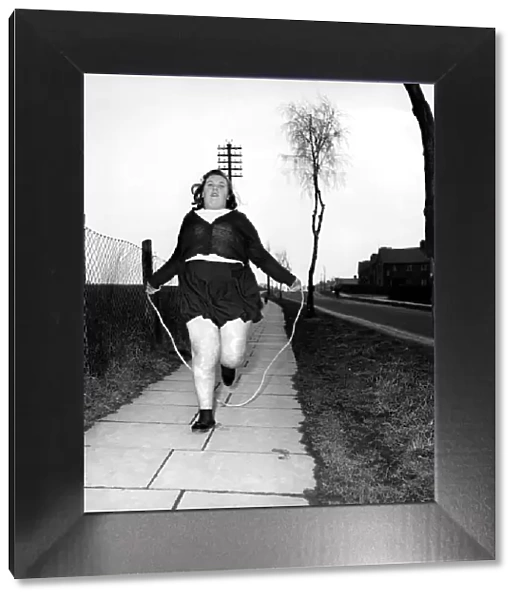 Slimming: Large woman skipping to get fit. A145-003