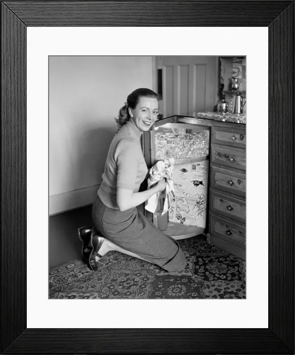 Framed Print : A busy housewife polishing the furniture at home Circa 1954 Framed Print : A busy housewife polishing the furniture at home Circa 1954