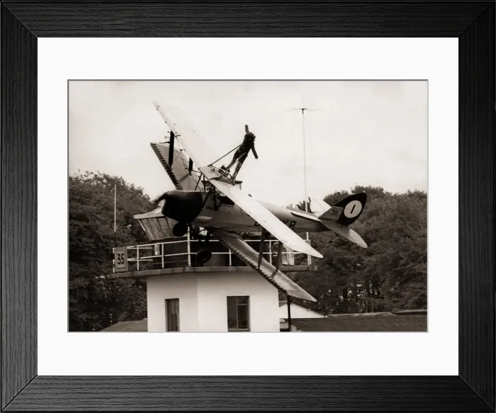 Framed Print : Lisa Winder 24 stands on top of a Tiger Moth Plane as it flys past the watch tower