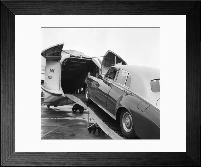 Framed Print : Actor Alec Guinness loading his Bently onto an aircraft bound for France where he will Framed Print : Actor Alec Guinness loading his Bently onto an aircraft bound for France where he will