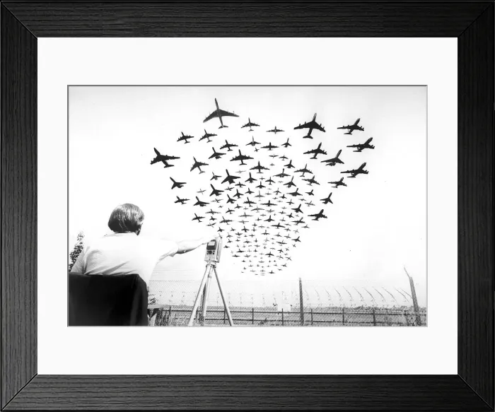 Framed Print : Multiple aircraft coming into land at Heathrow Airport with man sitting down monitoring