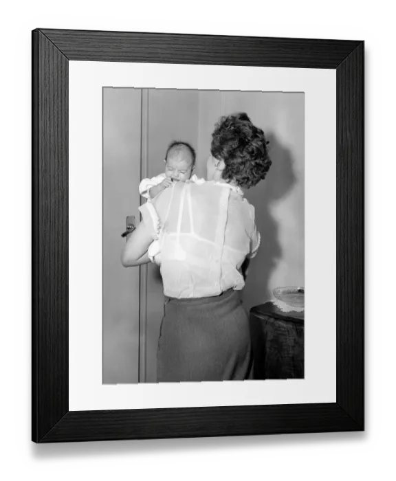 Framed Print : A mother holding her newly born baby in her arms Circa 1954
