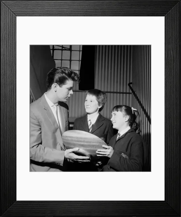 Framed Print : Singer Cliff Richard seen here presenting a school prize of three books to Carol Framed Print : Singer Cliff Richard seen here presenting a school prize of three books to Carol
