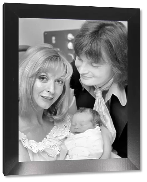 Actress: Nyree Dawn Porter with husband and baby. January 1975