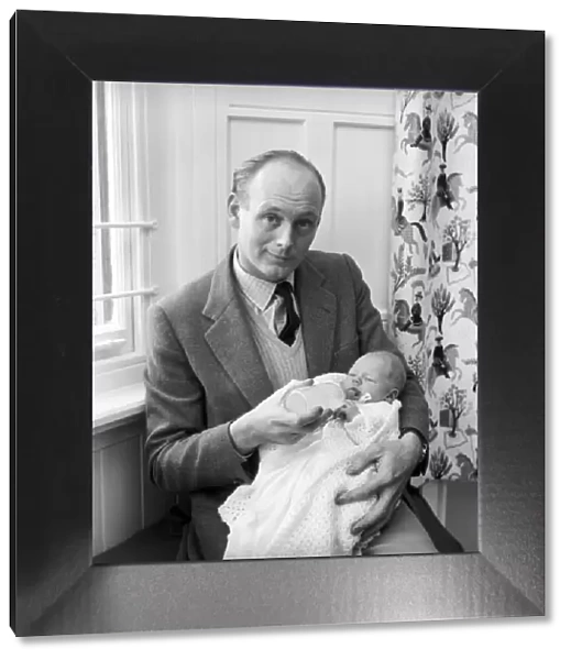 Lord Montagu of Beaulieu with his newborn son Ralph Montagu giving him his first feed at