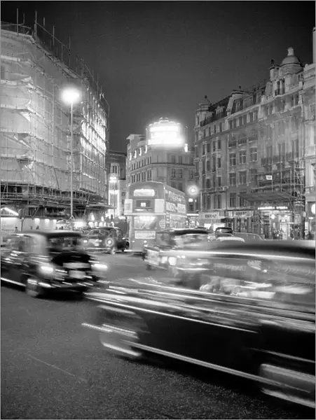 London taxis around Picadilly Circus at night. February 1987