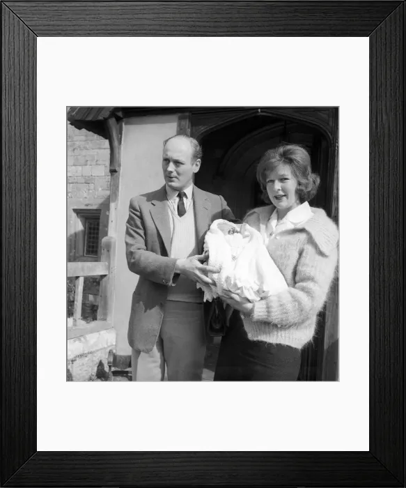 Framed Print : Lord Montagu and his wife, pictured on arrival at the Beaulieu, with the baby Ralph Framed Print : Lord Montagu and his wife, pictured on arrival at the Beaulieu, with the baby Ralph