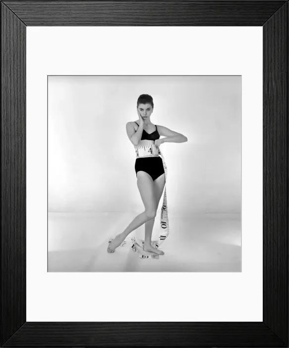 Framed Print : Model Gay Protheroe with outsize tape-measure. December 1956 Framed Print : Model Gay Protheroe with outsize tape-measure. December 1956