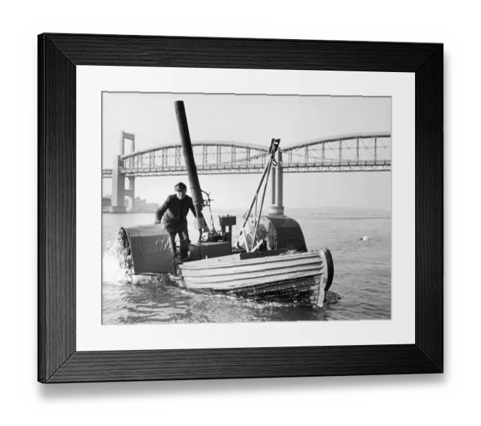 Framed Print : Sandy Pimlott and his Floating Bedstead, a homemade boat with a Morris 8 rear axle