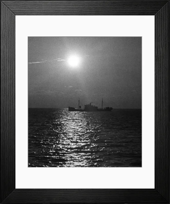 Framed Print : A cargo ship seen at sunset from the collier SS Petworth Framed Print : A cargo ship seen at sunset from the collier SS Petworth