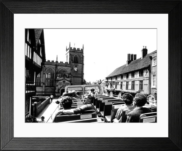 Framed Print : Visitors relaxing on the open-top bus as it travels through the streets of Framed Print : Visitors relaxing on the open-top bus as it travels through the streets of