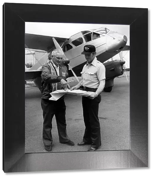 Pilots Mr Geoge LeMay(left) and Mr Alf Bicknell discussing the flight plan to Canada
