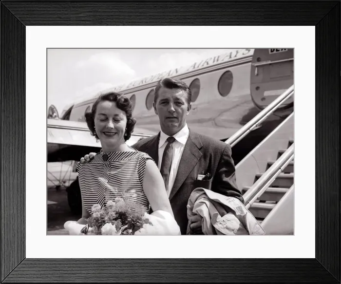 Framed Print : Robert Mitchum and his wife - July 1955 arrive at the London Airport
