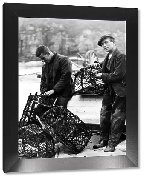 Ravages of the sea. Fishermen repairing crab pots on Tynemouth Haven. 12th September 1936