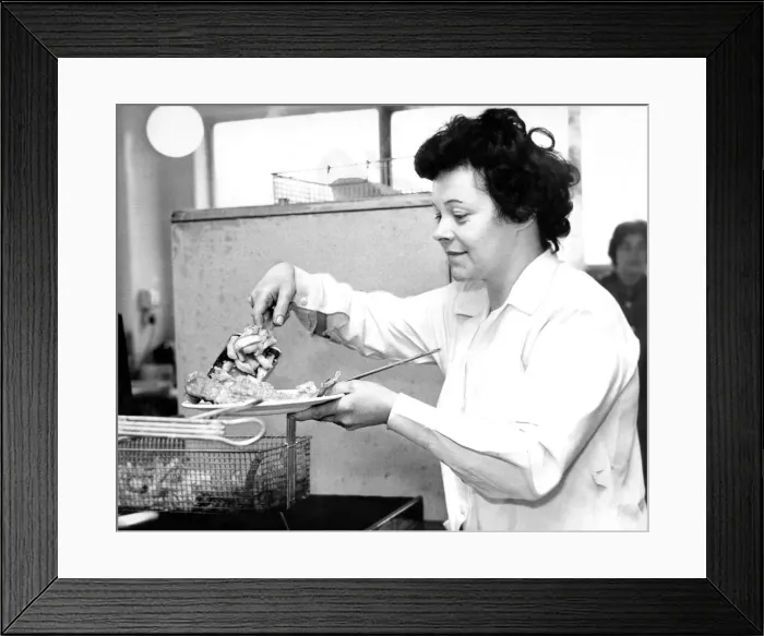 Framed Print : A women cooking traditional fish and chips Framed Print : A women cooking traditional fish and chips