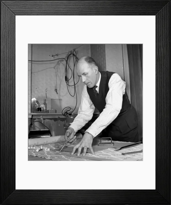 Framed Print : Mens Fashions: Tailor measuring and sewing in his workshop Framed Print : Mens Fashions: Tailor measuring and sewing in his workshop
