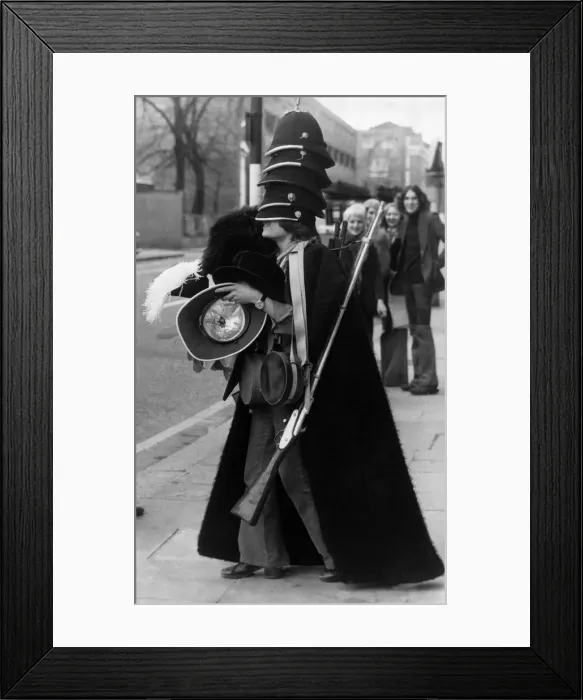 Framed Print : Army Uniforms over the years. Man models a bearskin, policemans helmets Framed Print : Army Uniforms over the years. Man models a bearskin, policemans helmets