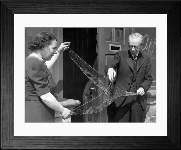 Framed Print : Mr. W. Fraser, stores manager at Irvins North Shields with a moedl trawl net in 1949 Framed Print : Mr. W. Fraser, stores manager at Irvins North Shields with a moedl trawl net in 1949