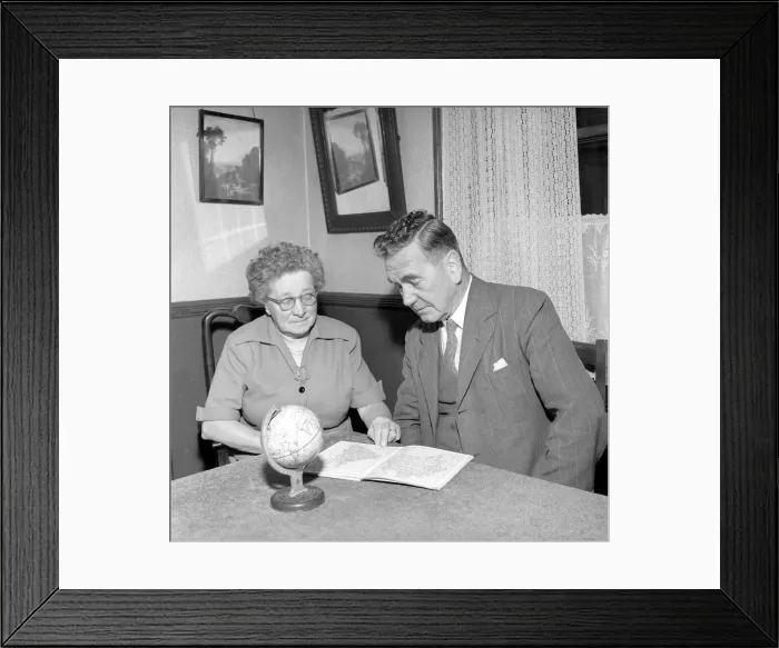 Framed Print : Holidays: Pensioners seen here looking at the globe deciding where to go to for their Framed Print : Holidays: Pensioners seen here looking at the globe deciding where to go to for their