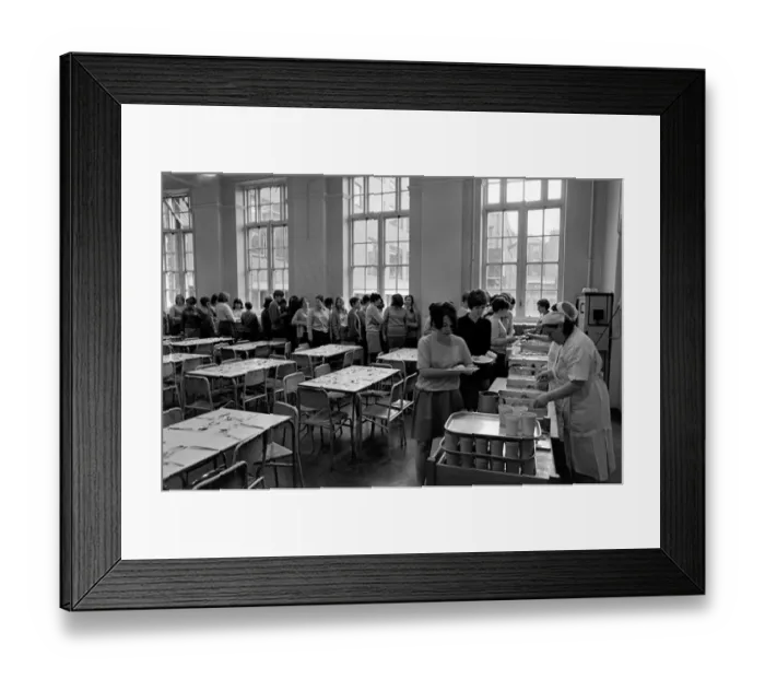 Framed Print : School Dinners. General scenes of school dinner. Ladies serving meal to pupils in