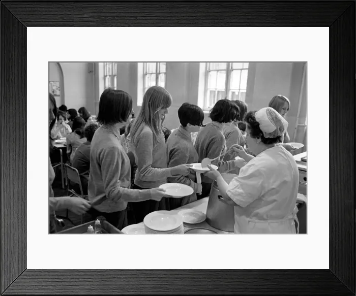 Framed Print : School Dinners. General scenes of school dinner. Ladies serving meal to pupils in Framed Print : School Dinners. General scenes of school dinner. Ladies serving meal to pupils in