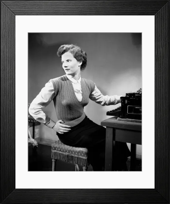 Framed Print : A secretary standing beside the typewriter in her office. June 1952 Framed Print : A secretary standing beside the typewriter in her office. June 1952