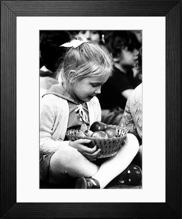 : Harvest Festival. Four year old Rebecca Jamewake keeps a tight grip on a basket of : Harvest Festival. Four year old Rebecca Jamewake keeps a tight grip on a basket of