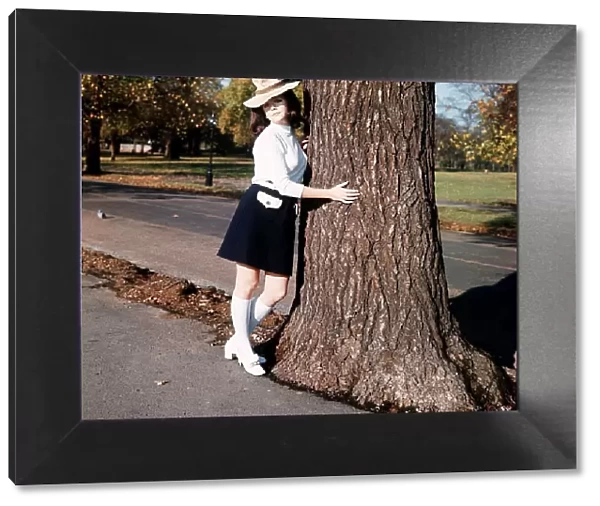 Linda Thorson, Actress, holding a tree trunk