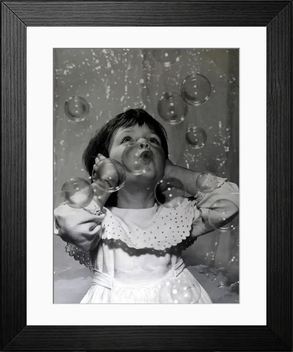 Framed Print : Small girl fascinated by the bubble machine at the 1959 Toy Fair This is a Framed Print : Small girl fascinated by the bubble machine at the 1959 Toy Fair This is a
