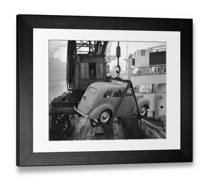 Framed Print : A crane operator seen here lifting one of the Ford Prefects