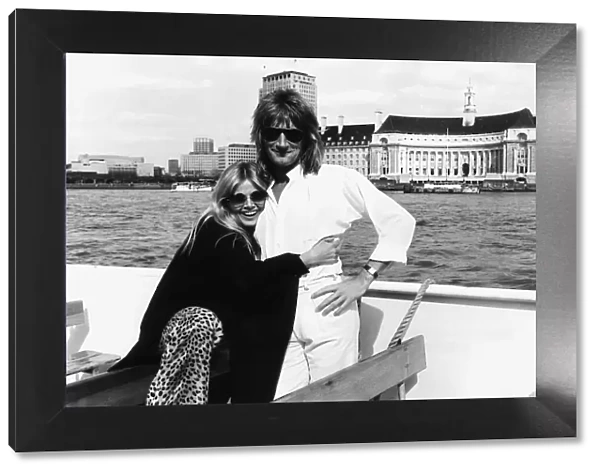 Rod Stewart singer with girlfriend Brit Ekland pose for a photograph during a boat trip