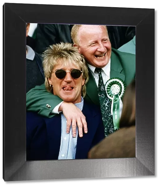 Jimmy Johnstone footballer with arm around singer Rod Stewart smiling tongue