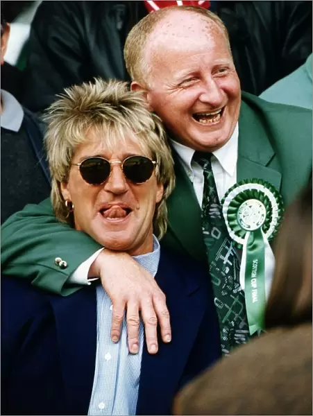 Jimmy Johnstone footballer with arm around singer Rod Stewart smiling tongue