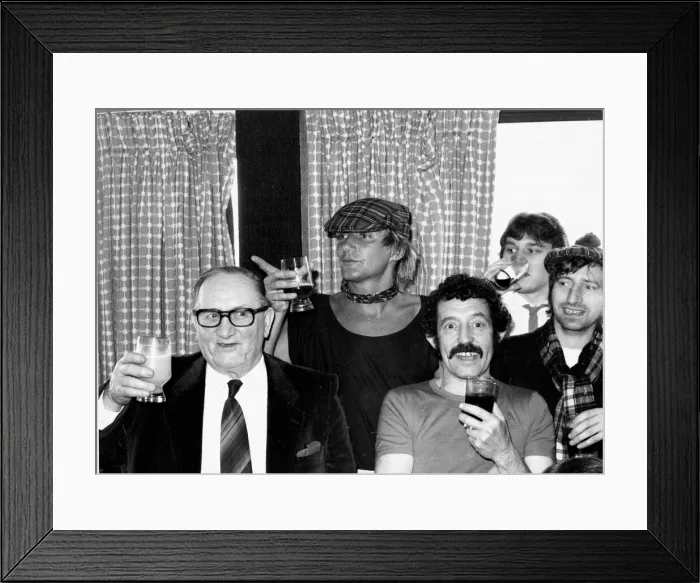 Framed Print : Scotlands Rock superstar Rod Stewart celebrates with a drink after the England v