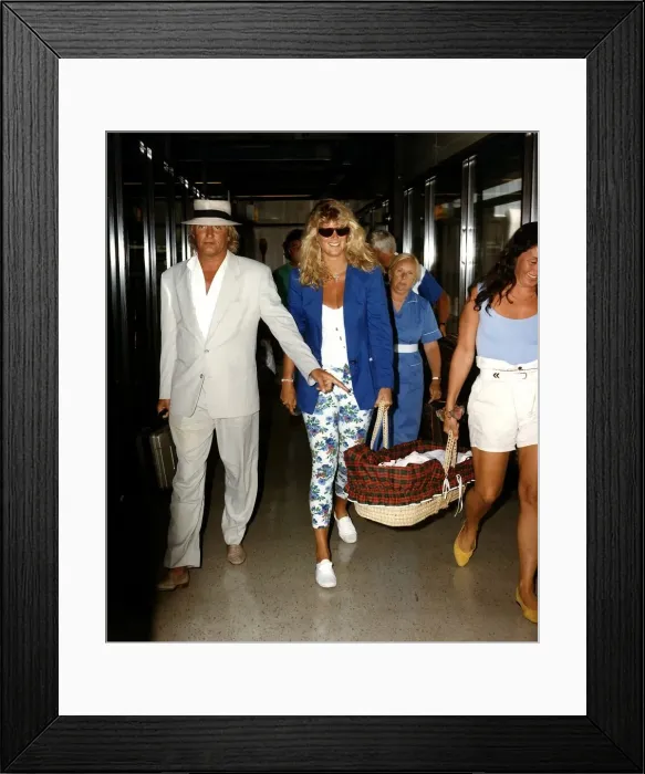 Framed Print : Rod Stewart and Rachel Hunter carring baby Renee arriving at Airport Framed Print : Rod Stewart and Rachel Hunter carring baby Renee arriving at Airport