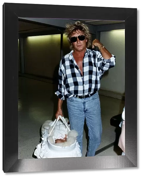 Rod Stewart Singer With baby daughter leaving Heathrow