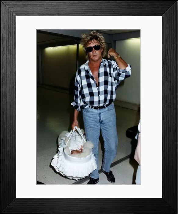 Framed Print : Rod Stewart Singer With baby daughter leaving Heathrow