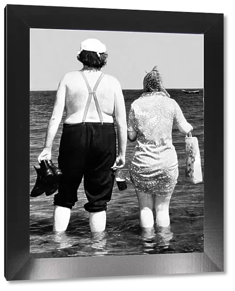 Typical Geordie couple Bill and Effie walk in the sea - Bill has his bottle of Brown Ale