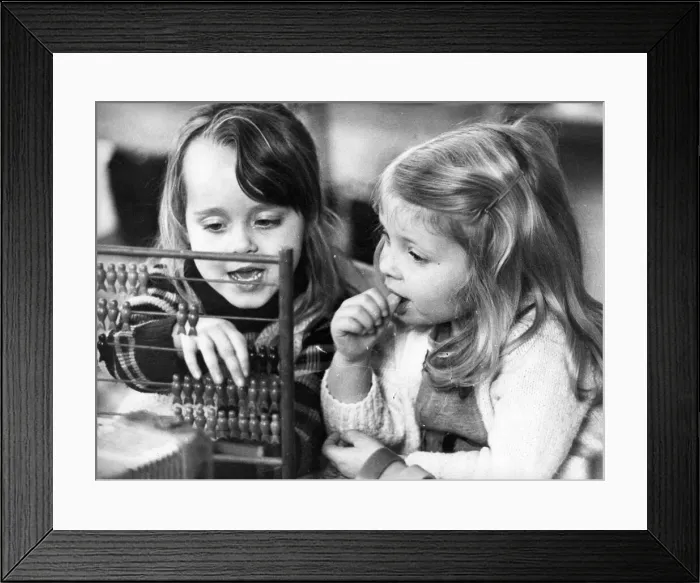 Framed Print : These young girls learn the art of calculating with the help of a abacus Framed Print : These young girls learn the art of calculating with the help of a abacus