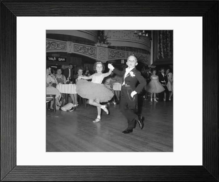 Framed Print : Eight year old Ralph Farish wearing a formal evening suit takes the hand of his partner