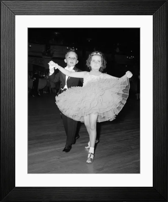 Framed Print : Eight year old Ralph Farish wearing a formal evening suit takes the hand of his partner Framed Print : Eight year old Ralph Farish wearing a formal evening suit takes the hand of his partner
