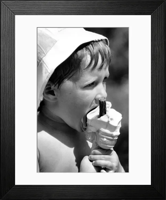 Framed Print : A young boy enjoys a 99 ice cream at Coventrys War Memorial Park Framed Print : A young boy enjoys a 99 ice cream at Coventrys War Memorial Park