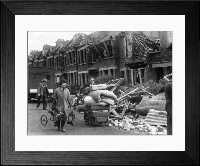 Framed Print : Couple carrying the remaining possessions from their bombed home in a pram following an Framed Print : Couple carrying the remaining possessions from their bombed home in a pram following an
