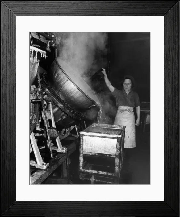 Framed Print : A factory worker tipping a huge cauldron of boiling jam Framed Print : A factory worker tipping a huge cauldron of boiling jam