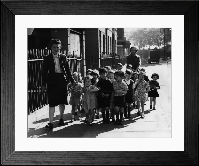 Framed Print : A nurse of Pimlico Day nursery takes the children out for a walk Framed Print : A nurse of Pimlico Day nursery takes the children out for a walk